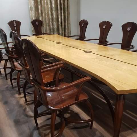 Long solid wood table with high-back wooden chairs