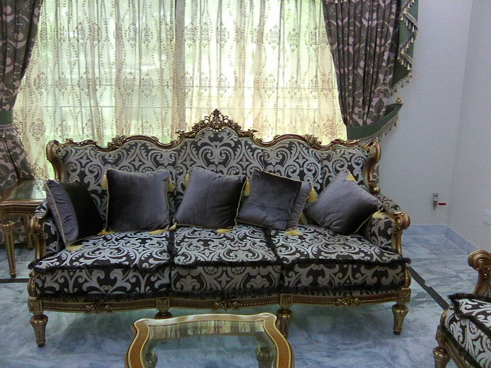 Three-seater sofa with carved gilded frame and dark damask upholstery