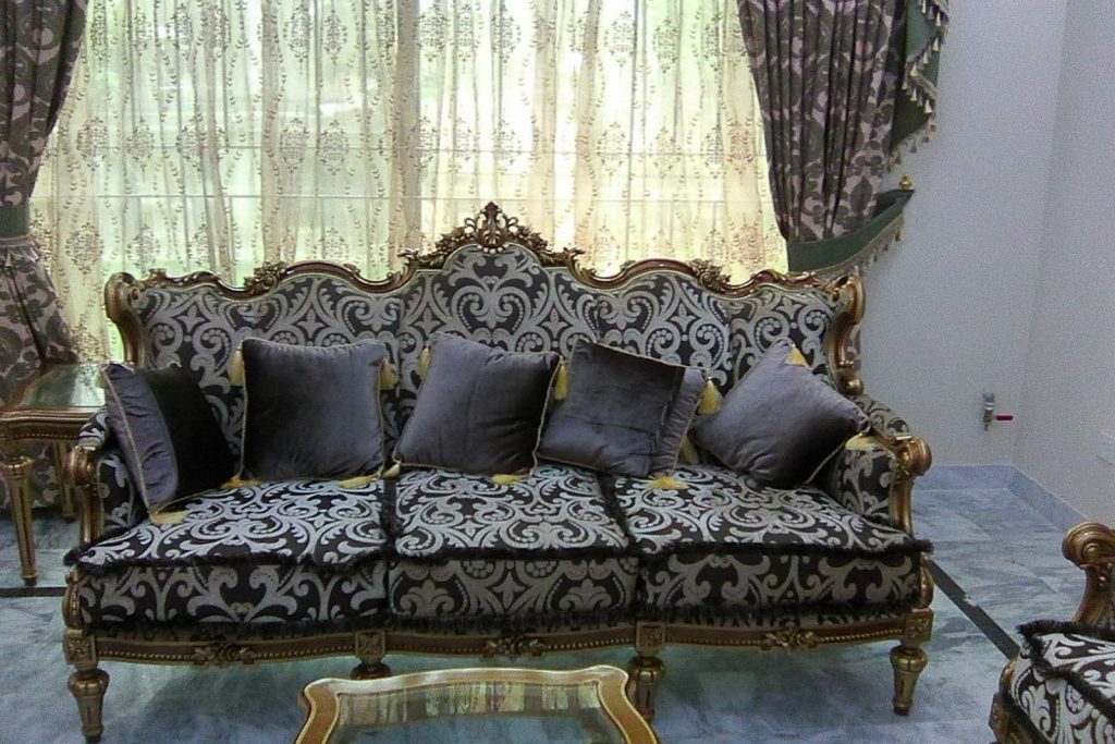 Carved sofa with gilded frame and dark damask upholstery