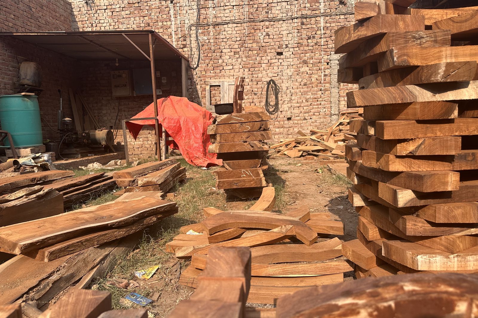 Stacks of sawn solid wood planks in the workshop yard