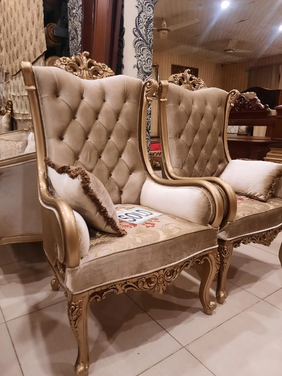 Gold tufted high-back armchair — front view