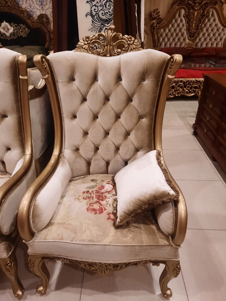 Gold tufted high-back armchair — angled view