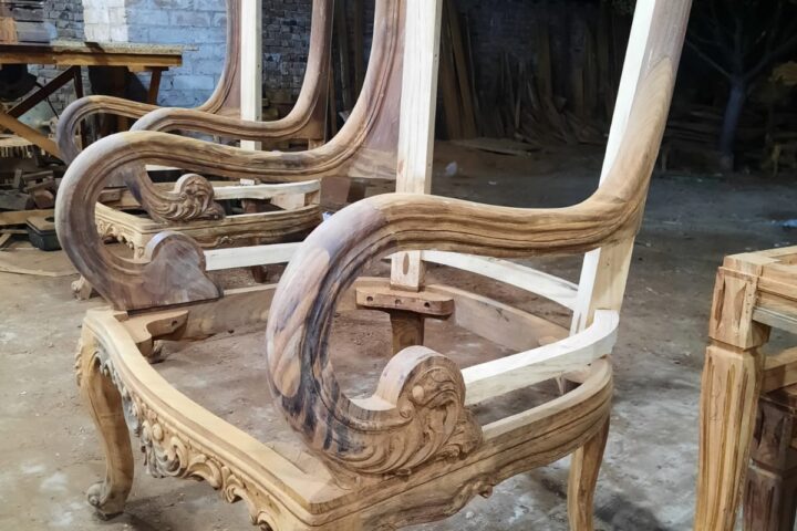Scroll-arm carved armchair — workshop photo, side view