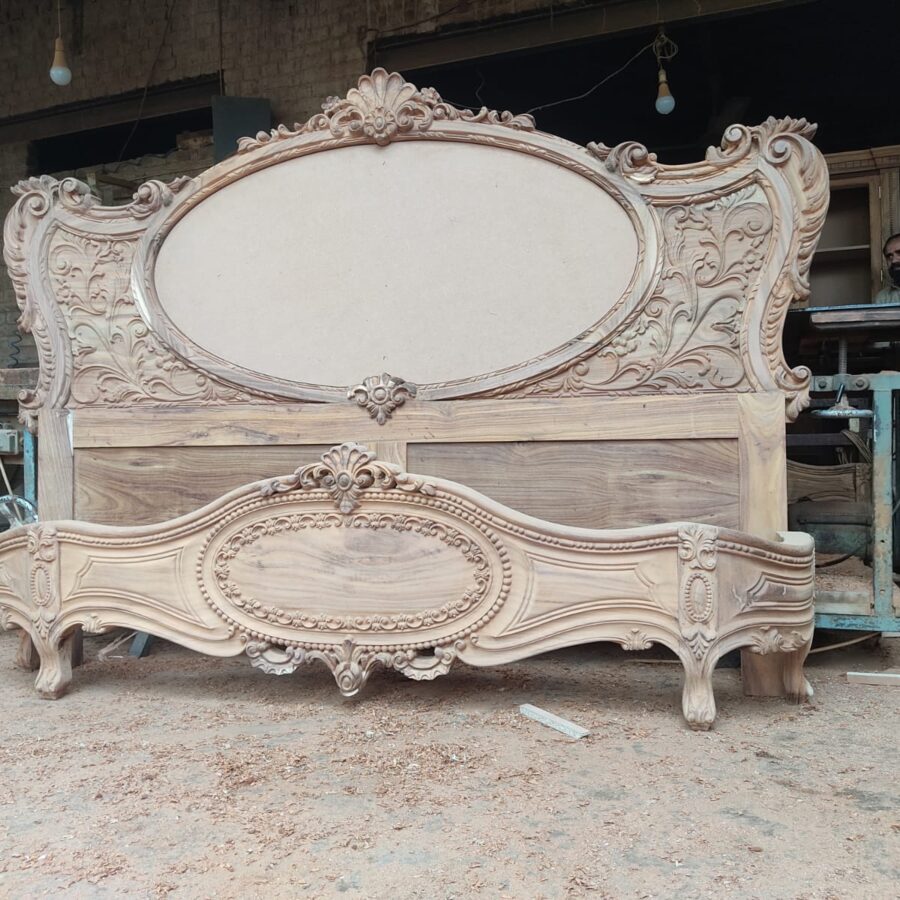 Oval medallion carved bed set — workshop photo before finishing