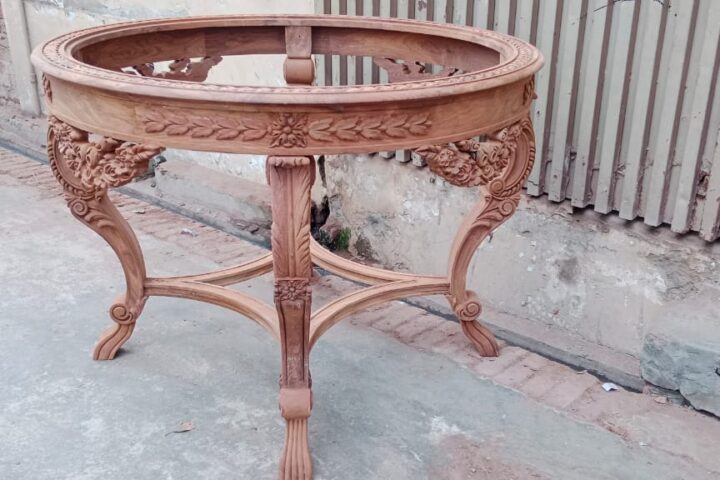 Round carved occasional table — workshop photo, front view