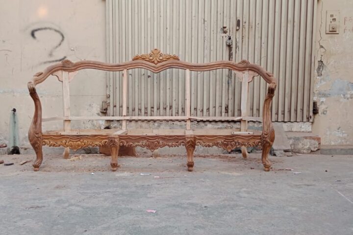Serpentine carved sofa — workshop photo, front view